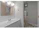 Bright bathroom featuring a modern vanity, stylish mirror, and tile flooring at 3932 Rounding Run Rd, Charlotte, NC 28277