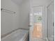 This bathroom features a soaking tub and an open doorway leading to a bright, spacious bedroom at 3932 Rounding Run Rd, Charlotte, NC 28277