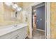 Powder room features a white vanity with chrome fixtures and yellow wallpaper at 3932 Rounding Run Rd, Charlotte, NC 28277