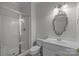 Bright bathroom featuring a modern vanity, stylish mirror, and a glass-enclosed shower at 3932 Rounding Run Rd, Charlotte, NC 28277