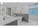 Luxurious bathroom with double sinks, soaking tub and frameless glass shower at 3932 Rounding Run Rd, Charlotte, NC 28277