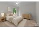 Staged bedroom featuring a bed, nightstands, and a wooden dresser at 3932 Rounding Run Rd, Charlotte, NC 28277