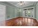 Bedroom with green walls, ceiling fan, natural light and access to outdoor space at 3932 Rounding Run Rd, Charlotte, NC 28277