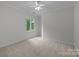 Bright bedroom with plush carpeting, neutral walls, and a ceiling fan at 3932 Rounding Run Rd, Charlotte, NC 28277