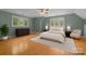 Serene bedroom features hardwood floors, neutral decor, and ample natural light at 3932 Rounding Run Rd, Charlotte, NC 28277