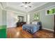 Bright bedroom with hardwood floors, ample natural light, and a ceiling fan at 3932 Rounding Run Rd, Charlotte, NC 28277