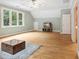 Spacious bedroom with wood floors, large windows offering wooded views, and a ceiling fan for added comfort at 3932 Rounding Run Rd, Charlotte, NC 28277