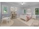 Staged bedroom with soft carpet, neutral walls, and multiple windows that bring in natural light at 3932 Rounding Run Rd, Charlotte, NC 28277