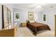 Comfortable bedroom with neutral carpet, ample natural light, and a traditional wood dresser at 3932 Rounding Run Rd, Charlotte, NC 28277