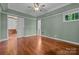 Spacious bedroom with wood floors, green walls, ceiling fan and natural light at 3932 Rounding Run Rd, Charlotte, NC 28277