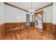 Elegant dining room featuring hardwood floors, classic wood trim, and a doorway with glass panes at 3932 Rounding Run Rd, Charlotte, NC 28277