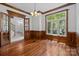 Spacious dining area with hardwood floors, detailed trim, and large windows that flood the space with light at 3932 Rounding Run Rd, Charlotte, NC 28277