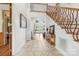 Bright foyer with tile flooring, an elegant staircase, and views into the living room, creating an inviting entrance at 3932 Rounding Run Rd, Charlotte, NC 28277