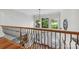 Second floor foyer with hardwood floors and a decorative railing overlooking the front entry at 3932 Rounding Run Rd, Charlotte, NC 28277