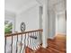 Second floor hallway with hardwood floors and a decorative railing overlooking the front entry at 3932 Rounding Run Rd, Charlotte, NC 28277