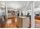 Gourmet kitchen with granite island, stainless steel appliances, and hardwood floors at 3932 Rounding Run Rd, Charlotte, NC 28277