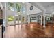Open living room featuring high ceilings, hardwood floors, and plenty of natural light from large windows and doors at 3932 Rounding Run Rd, Charlotte, NC 28277