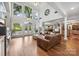 Expansive living room with soaring ceilings, large windows, and a seamless flow into the kitchen and dining area at 3932 Rounding Run Rd, Charlotte, NC 28277