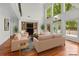 Bright living room with a fireplace, built-in shelves, and large windows offering lots of natural light at 3932 Rounding Run Rd, Charlotte, NC 28277