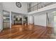 Expansive living space with gleaming hardwood floors, soaring ceilings, and elegant architectural details at 3932 Rounding Run Rd, Charlotte, NC 28277