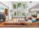Bright and airy living room with large windows, a fireplace, hardwood floors, and comfortable seating at 3932 Rounding Run Rd, Charlotte, NC 28277