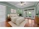 Comfortable bedroom with a soft rug, wooden floors, and double doors to the outside at 3932 Rounding Run Rd, Charlotte, NC 28277