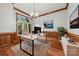 Bright and airy office space featuring classic wood trim, hardwood floors, and a view of the exterior at 3932 Rounding Run Rd, Charlotte, NC 28277