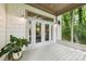Relaxing outdoor deck with screened-in porch overlooking the lush wooded backyard of the property at 3932 Rounding Run Rd, Charlotte, NC 28277