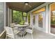 Cozy screened porch with a ceiling fan, providing a relaxing outdoor space with views of the surrounding greenery at 3932 Rounding Run Rd, Charlotte, NC 28277