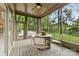 Inviting screened porch with seating area and views of the lush, green backyard at 3932 Rounding Run Rd, Charlotte, NC 28277