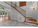 Elegant staircase featuring detailed ironwork and warm wood accents, complemented by a light-filled entryway at 3932 Rounding Run Rd, Charlotte, NC 28277