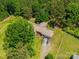 Aerial view of the home showcasing its location surrounded by lush green trees and a long driveway at 40278 Nc 740 Hwy, New London, NC 28127