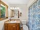 Traditional bathroom features a vanity with built in sink and blue and white patterned shower curtain at 40278 Nc 740 Hwy, New London, NC 28127