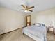 Bedroom with neutral carpet, a ceiling fan, and a comfortable bed with stylish blue and white patterned bedding at 40278 Nc 740 Hwy, New London, NC 28127