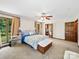 Bedroom with light walls, neutral carpet, closet, and windows overlooking a verdant backyard at 40278 Nc 740 Hwy, New London, NC 28127