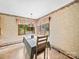 Dining room with wallpaper, wood framed windows, and a table set for dining at 40278 Nc 740 Hwy, New London, NC 28127