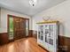 Inviting foyer featuring wood floors, wooden door with glass panels, and charming cabinet at 40278 Nc 740 Hwy, New London, NC 28127