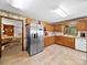 Traditional style kitchen with stainless steel refrigerator and tile floor at 40278 Nc 740 Hwy, New London, NC 28127