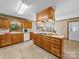Spacious kitchen with wood cabinets, tile floors and white appliances and a large island at 40278 Nc 740 Hwy, New London, NC 28127