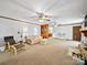 Cozy living room with white walls, neutral carpet and a fireplace at 40278 Nc 740 Hwy, New London, NC 28127