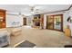 Open-concept living room with a stone fireplace and sliding glass doors at 40278 Nc 740 Hwy, New London, NC 28127