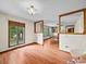 Open living room with hardwood floors, large windows and adjoining dining area at 40278 Nc 740 Hwy, New London, NC 28127