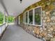 Spacious porch featuring a stone facade and views of the property at 40278 Nc 740 Hwy, New London, NC 28127