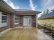 Covered brick back patio with double doors leading to interior, perfect for relaxing or entertaining at 405 Newstyle Way, Gastonia, NC 28056