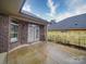 Covered brick back patio with double doors leading to interior, perfect for relaxing or entertaining at 405 Newstyle Way, Gastonia, NC 28056