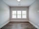 Bright bedroom with three large windows, ceiling fan, and stylish flooring at 405 Newstyle Way, Gastonia, NC 28056