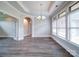 Dining room with a modern chandelier, large windows, hardwood flooring, and archway at 405 Newstyle Way, Gastonia, NC 28056