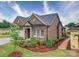 Beautiful exterior view of brick home showcasing landscaping and well-maintained surroundings at 405 Newstyle Way, Gastonia, NC 28056
