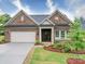 Charming single Gathering home features brick facade, manicured landscaping, and attached garage at 405 Newstyle Way, Gastonia, NC 28056