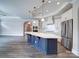 Bright kitchen with a navy blue island, stainless steel appliances, and hardwood floors at 405 Newstyle Way, Gastonia, NC 28056